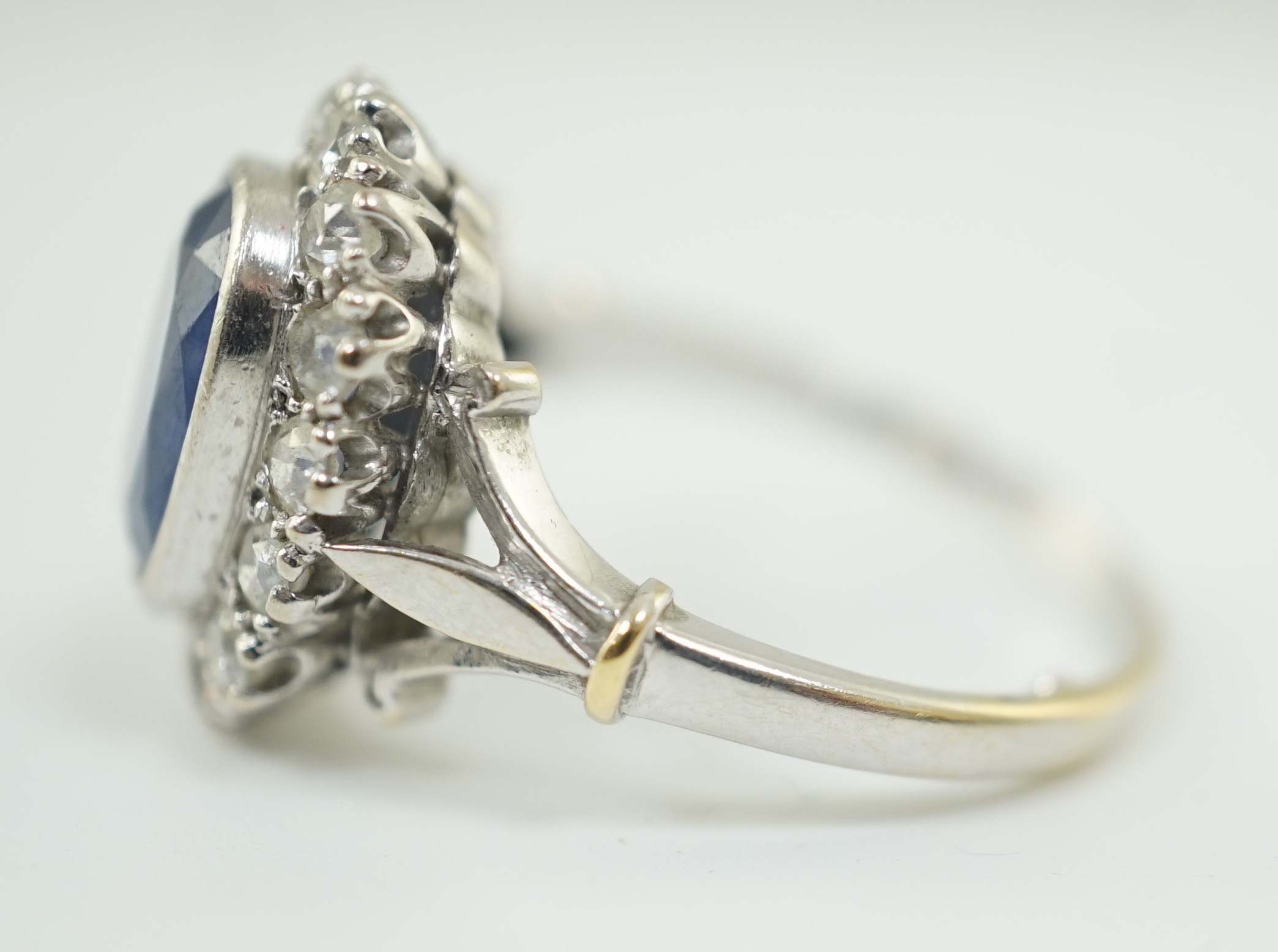 An 18ct white gold, sapphire and diamond set oval cluster ring